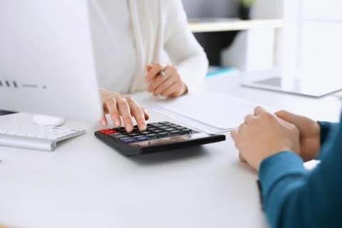 Accountant checking financial statement or counting by calculator income for tax Stock Photos