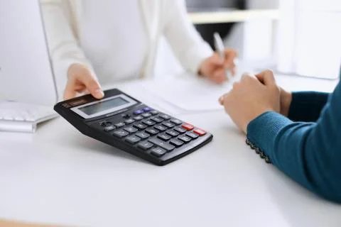 Accountant checking financial statement or counting by calculator income for tax Stock Photos