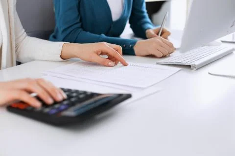 Accountant checking financial statement or counting by calculator income for tax Stock Photos