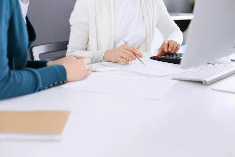 Accountant checking financial statement or counting by calculator income for tax Stock Photos