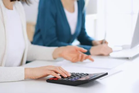 Accountant checking financial statement or counting by calculator income for tax Stock Photos