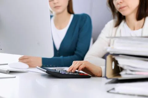 Accountant checking financial statement or counting by calculator income for tax Stock Photos