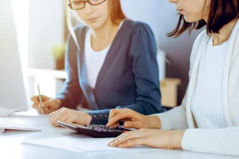 Accountant checking financial statement or counting by calculator income for tax Stock Photos