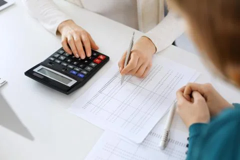 Accountant checking financial statement or counting by calculator income for tax Foto stock