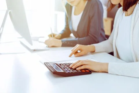 Accountant checking financial statement or counting by calculator income for tax Stock Photos