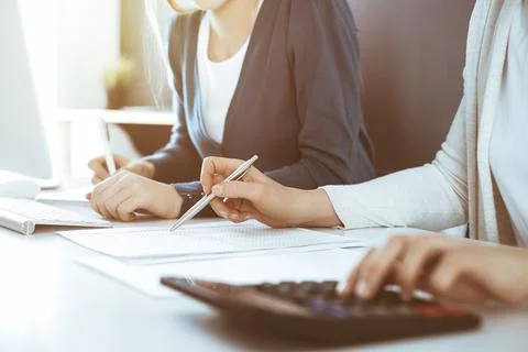 Accountant checking financial statement or counting by calculator income for tax Stock Photos