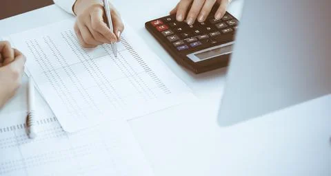 Accountant checking financial statement or counting by calculator income for tax Stock Photos