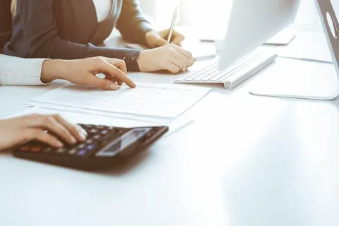 Accountant checking financial statement or counting by calculator income for tax Stock Photos