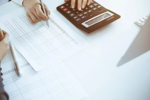 Accountant checking financial statement or counting by calculator income for tax Stock Photos