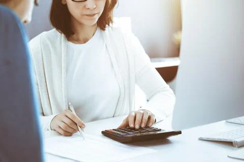Accountant checking financial statement or counting by calculator income for tax Stock Photos