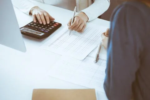 Accountant checking financial statement or counting by calculator income for tax Stock Photos