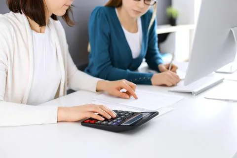 Accountant checking financial statement or counting by calculator income for tax Stock Photos