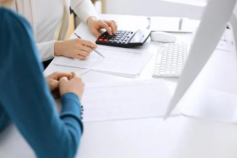 Accountant checking financial statement or counting by calculator income for tax Stock Photos