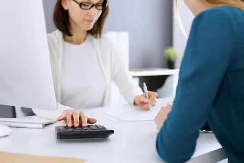 Accountant checking financial statement or counting by calculator income for tax Stock Photos
