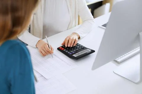 Accountant checking financial statement or counting by calculator income for tax Stock Photos
