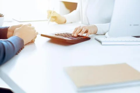 Accountant checking financial statement or counting by calculator income for tax Stock Photos