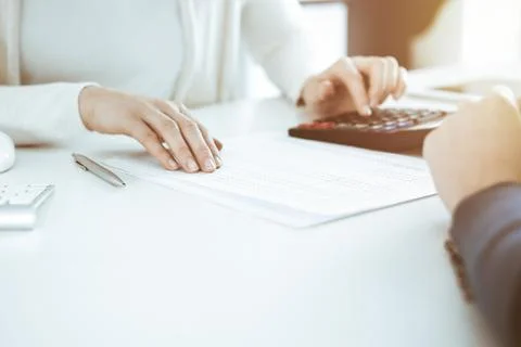 Accountant checking financial statement or counting by calculator income for tax Stock Photos