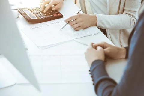 Accountant checking financial statement or counting by calculator income for tax Stock Photos