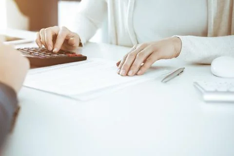Accountant checking financial statement or counting by calculator income for tax Stock Photos