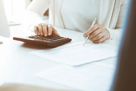 Accountant checking financial statement or counting by calculator income for tax Stock Photos