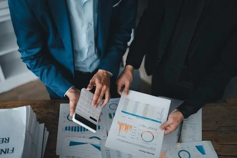 Accountant checking financial statement or counting by calculator income for tax Stock Photos