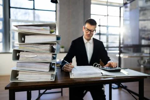 Accountant With Folders Paper Stack Doing Invoice Foto stock