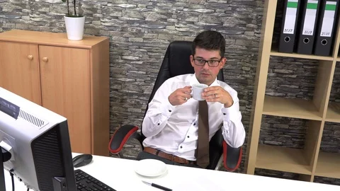 Accountant in the office is drinking coffee talking to a client Stock Footage 115879264