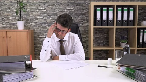 An accountant in an office suffers a headache Stock Footage 116080652