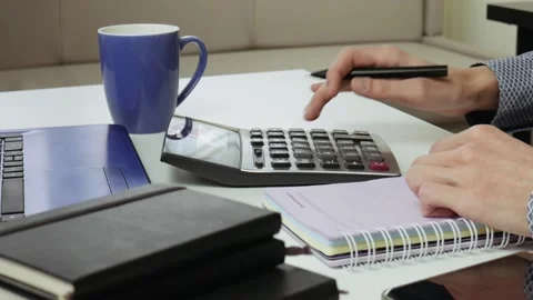 Accountant or manager making calculations and taking notes in notebook at work. Stock Footage 101700032