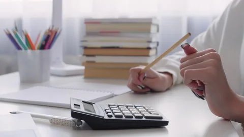 Accountant using calculator and taking notes Stock Footage 315175131