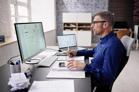 Accountant Using E Invoice Software At Computer Foto stock