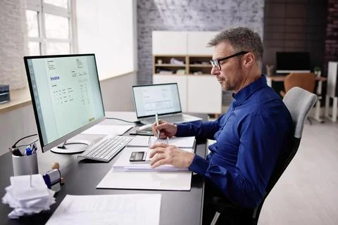 Accountant Using E Invoice Software At Computer Foto stock