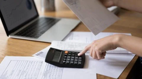 Accountant woman calculating expenses, fees, analyzing financial reports Stock Photos