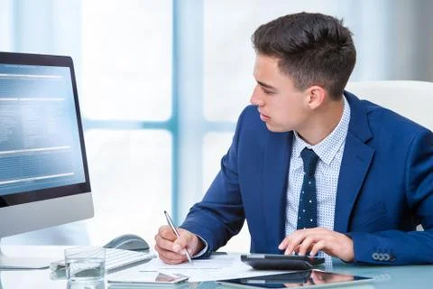Accountant working on budget at desk. Stock Photos