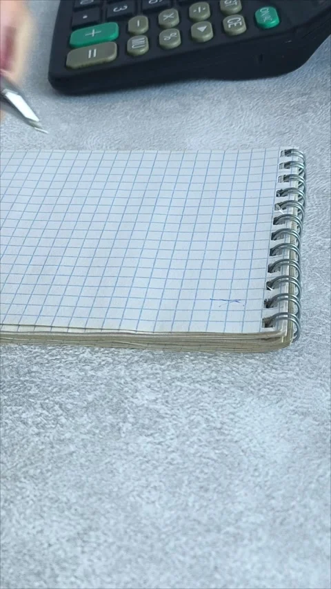 Accountant working on desk using calculator to calculate financial report Stock Footage 313100191