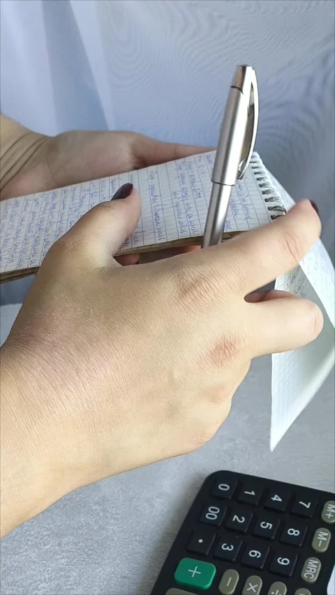 Accountant working on desk using calculator to calculate financial report Video stock 313101060