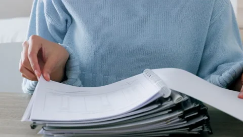 Accountant working with a stack of finance documents or books while audit data Stock Footage 225419912
