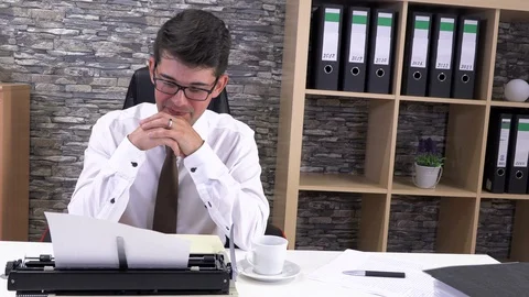 Accountant writes on a typewriter at a table in the workplace Stock Footage 115723383