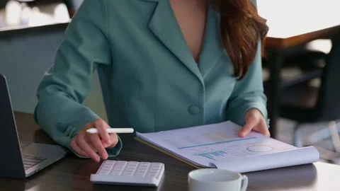 Accountants are using a calculator to calculate the sales increase from the Stock Footage 192196480