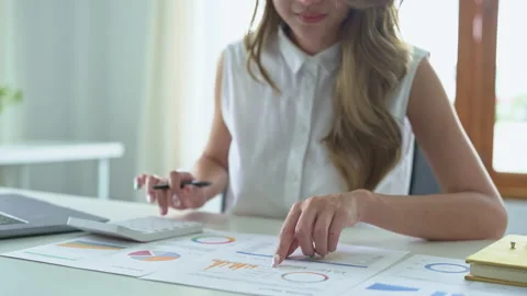 Accountants, Asian auditors are using calculators and computers to review annual Stock Footage 220830893