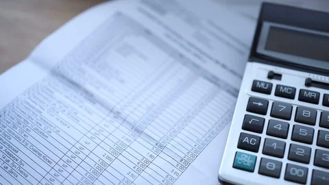 Accounting documents on a table around a calculator. Stock Footage 123595553
