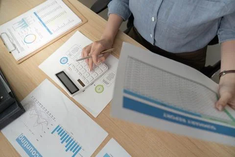 Accounting Professional Analyzing Financial Data with Calculator Stock Photos