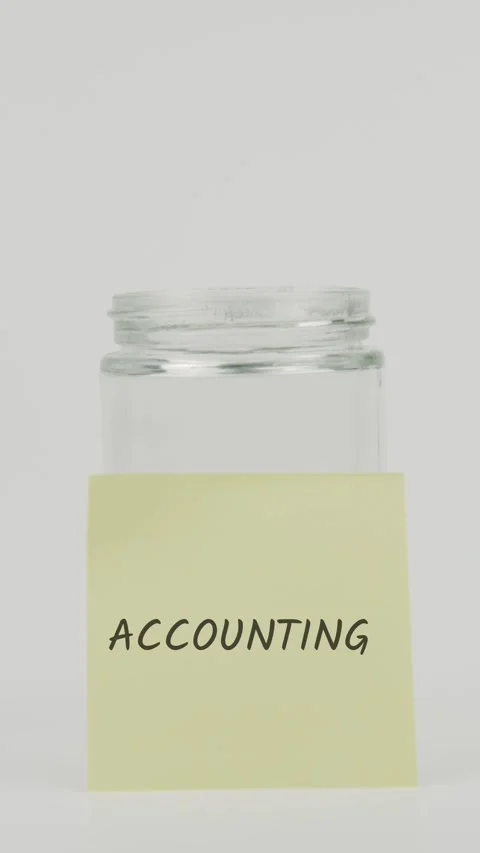 Accounting text or word on yellow sticky note attached to glass jar Stock Footage 311675221