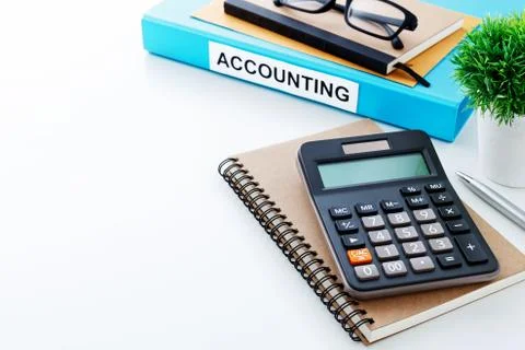 Accounting work background with calculator on notebook and space Stock Photos