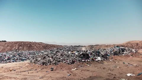 Accumulation of second-hand clothes in clandestine landfill generating a Video stock 257526425