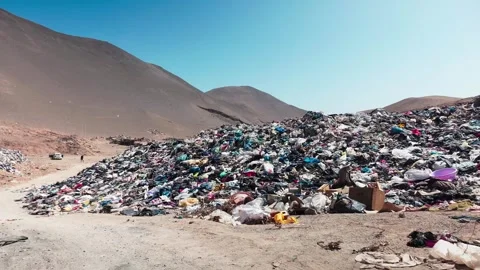 Accumulation of second-hand clothes in clandestine landfill generating a Stock Footage 257526431