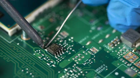 Accuracy. Electronic lab working place with soldering iron and circuit board Stock Footage