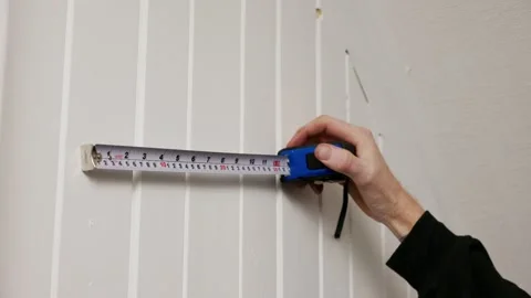 Accurate wall measurement using tape measure Stock Footage 325847513