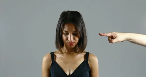 An accusing hand points to a woman's face, humiliating her Stock Footage 157265717