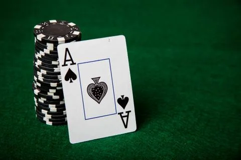 Ace of spades leaning on stack of black poker chips. Stock Photos